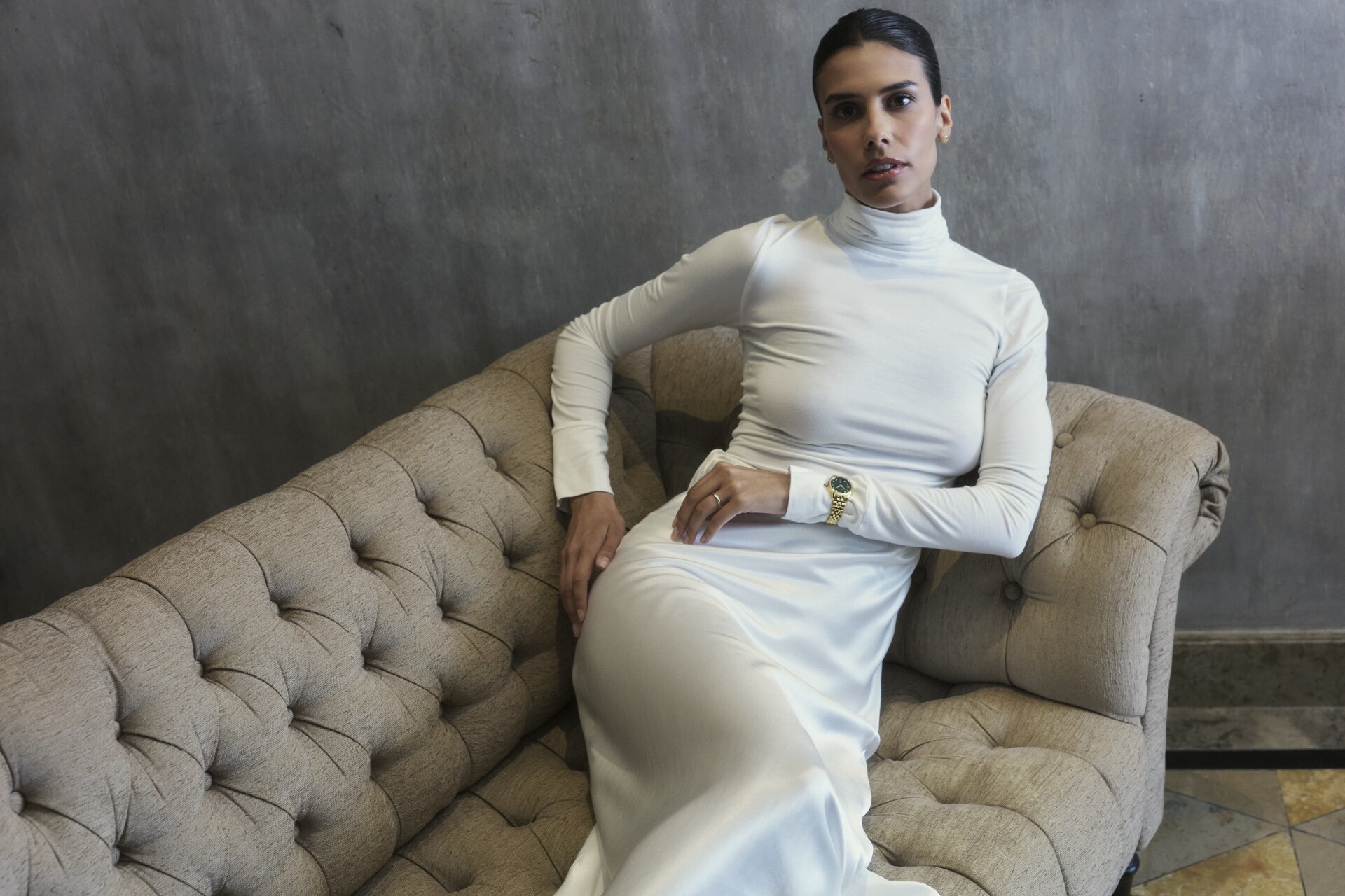 Wrist shot of a Balmain Ophrys Lady watch with a mint green dial, mint green rubber strap, and stainless steel case.