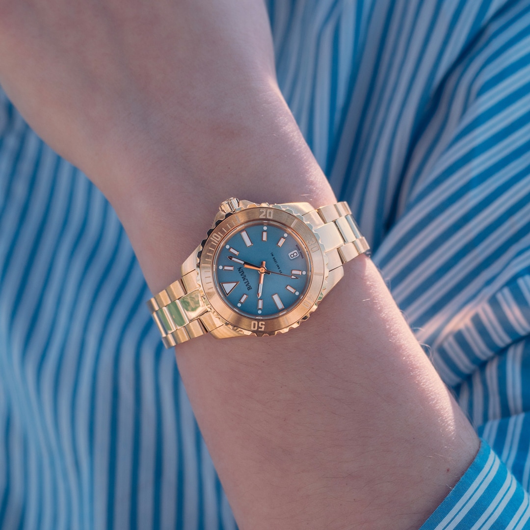 Lifestyle wrist shot of the Balmain Ophrys watch, showcasing its fresh rose gold PVD tones and elegant sporty design on a woman’s wrist.
