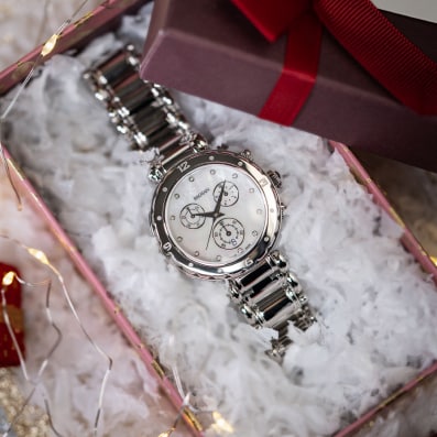 Close-up of Balmain festive collection watch featuring Parisian Haute Couture design