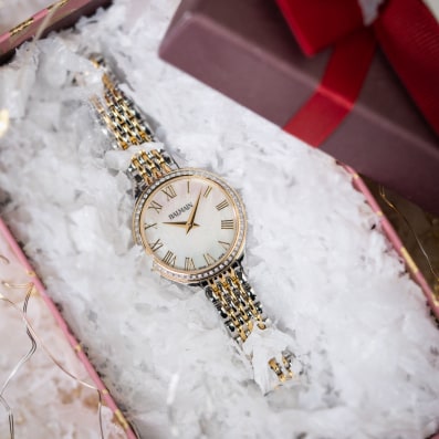 Close-up of Balmain festive collection watch featuring Parisian Haute Couture design
