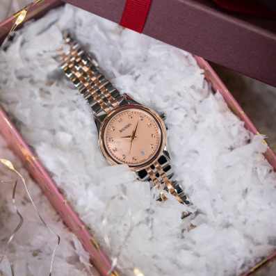 Close-up of Balmain festive collection watch featuring Parisian Haute Couture design