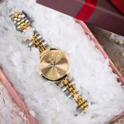 Close-up of Balmain festive collection watch featuring Parisian Haute Couture design