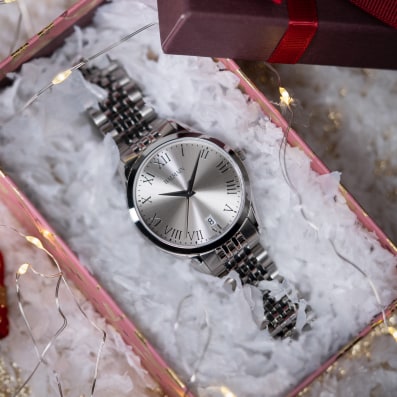 Close-up of Balmain festive collection watch featuring Parisian Haute Couture design