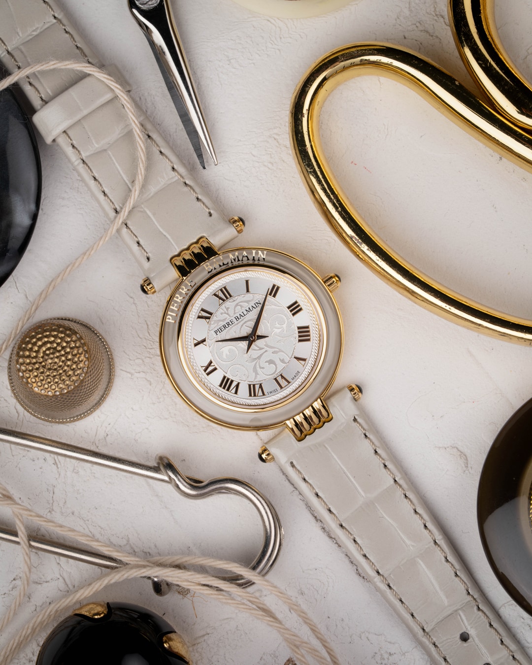 The "Pierre Balmain" on the bezel adds an expressive touch, while the leather strap completes the look, offering everyday style.